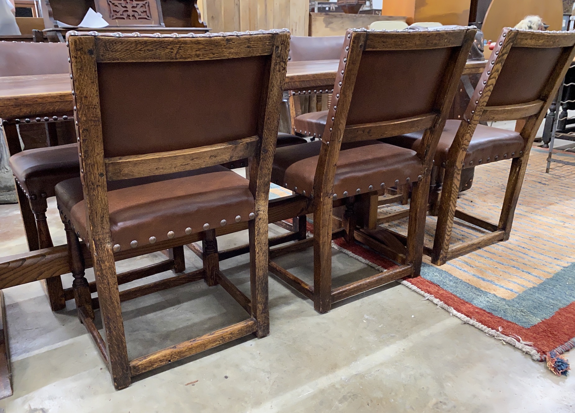 An 18th century style rectangular oak refectory dining table, length 214cm, depth 78cm, height 75cm together with a set of eight oak dining chairs